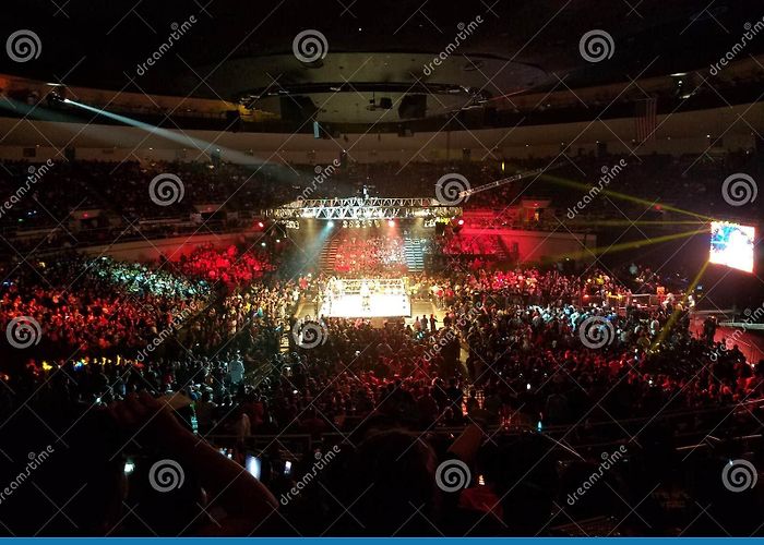 Neal S. Blaisdell Center WWE Wrestlers in Match in Ring with Crowd Watching at WWE Event ... photo